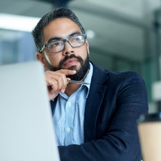 man with glasses at laptop