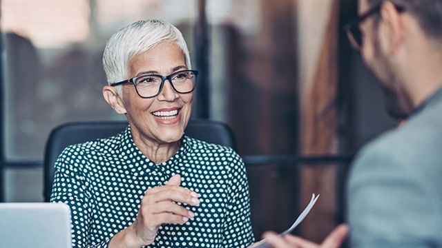 woman with glasses smiling