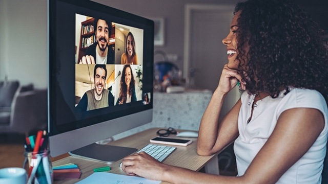 Woman smiling sitting at screen