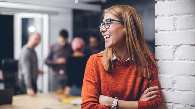 woman with glasses smiling