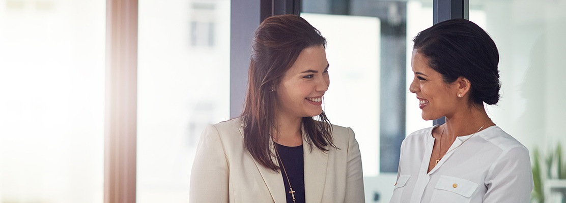 two business women laughing