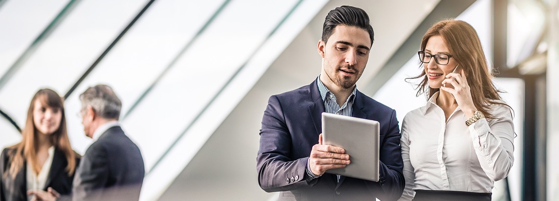 two business people with ipad and phone