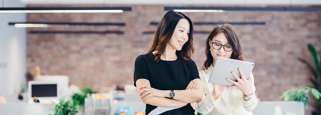 Two business women on ipad