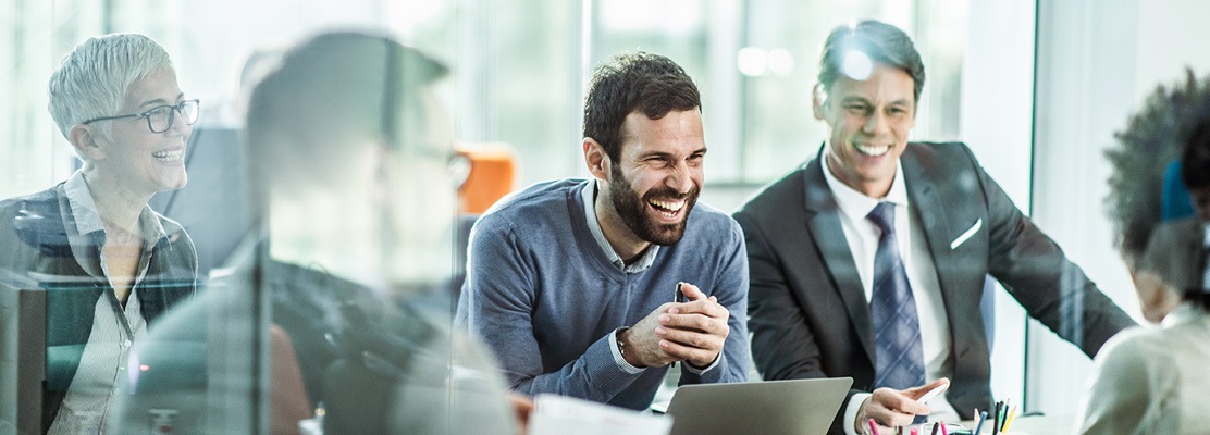 Business People Sitting at table laughing