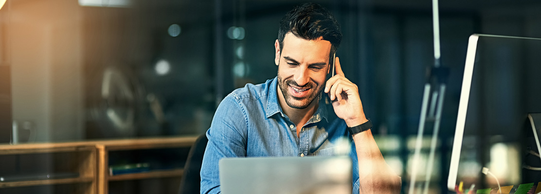 Professional with IT equipment at office desk