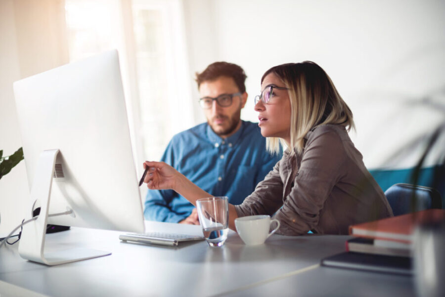 two people working at a desktop