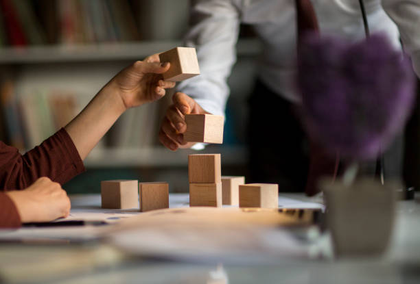 People building a structure with blocks