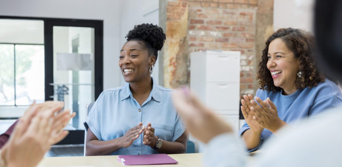 Colleagues clap in congratulations